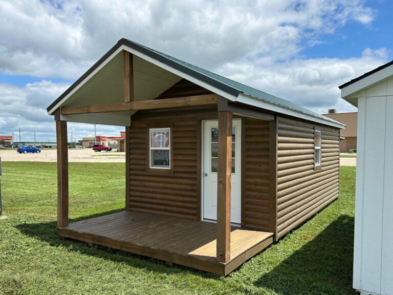 12x26 Log sided cabin with white trim, and fern green metal roof for custom order to Ames, IA