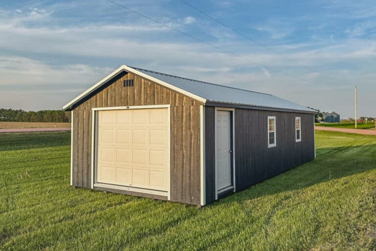 14x26 garage on a farm with gray siding and a metal roof