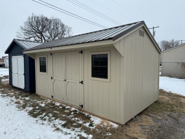 Beige Quaker shed in shed lot