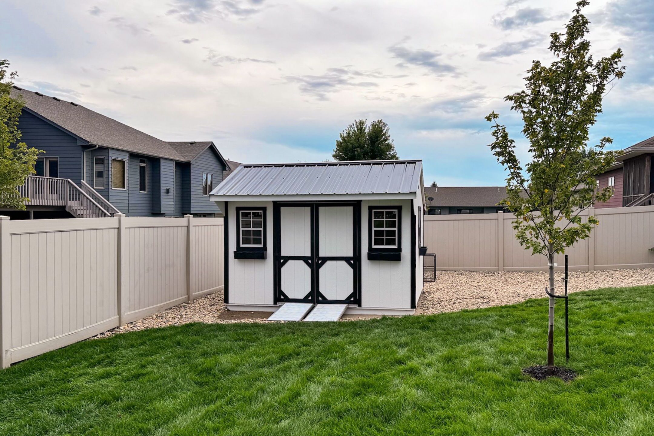 White quaker shed in backyard