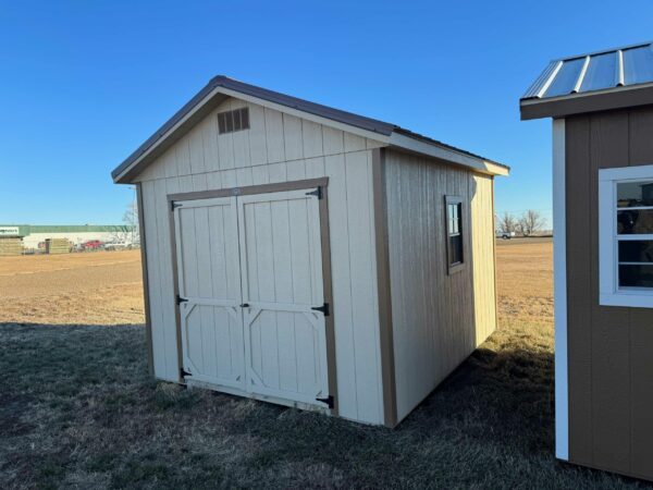 Beige Ranch shed in shed lot